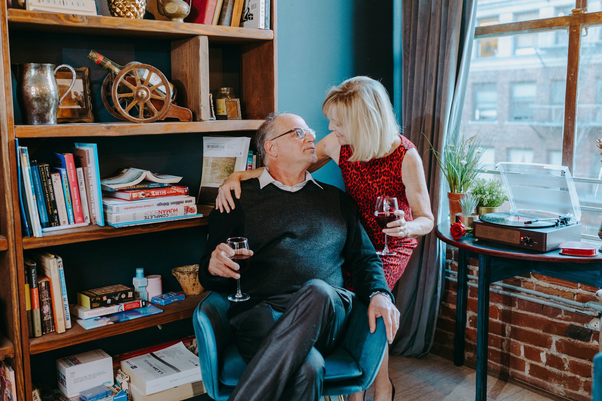Retired couple enjoying a glass of wine at home - Is it time to downsize your home - Dewar Realty - The Real Estate Blog
